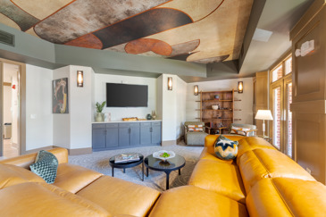 Creekstone at RTP apartment clubhouse with a seating area next to large signage and a wavy carpet over a dark wooden floor